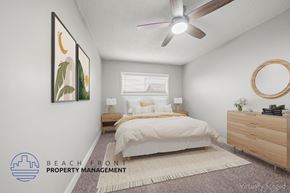 Hawthorne apartment for rent - A bedroom with a bed, nightstand, and a ceiling fan.