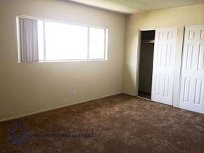 Inglewood apartment for rent - a room with carpet and a window and two doors