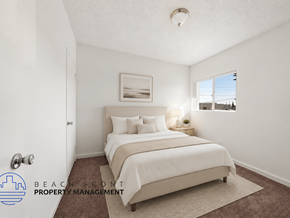 Wilmington apartment for rent - A bedroom with a large bed and a window overlooking the beach.