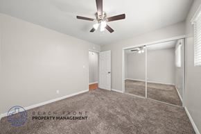 Stanton apartment for rent - A spacious room with a ceiling fan and a sliding glass door leading to a balcony.
