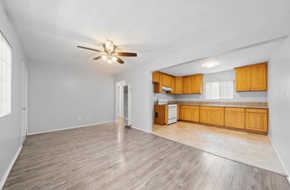 Long Beach apartment for rent - A room with a ceiling fan and wooden flooring.