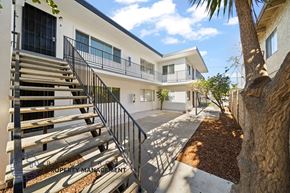 Tustin apartment for rent - a house with stairs and a tree in front of it