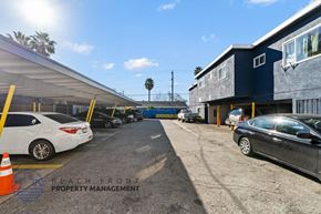 Cudahy apartment for rent - a parking lot with cars in front of a building