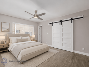 Hawthorne apartment for rent - A bedroom with a bed, a ceiling fan, and a sliding door.