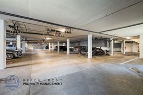 Long Beach apartment for rent - A spacious parking garage with multiple cars parked inside.