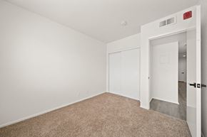 Long Beach apartment for rent - a bedroom with white walls and carpet and a door to a closet