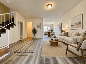 Lawndale apartment for rent - A living room with a couch, coffee table, and a staircase.