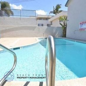 Inglewood apartment for rent - a swimming pool in front of a building