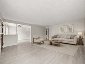 Anaheim apartment for rent - A living room with a white couch, a wooden coffee table, and a rug.