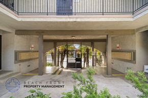 Gardena apartment for rent - A building entrance with a sign that says Beach Front Property Management.
