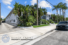 Downey apartment for rent - a car is parked on the street in front of a white building with palm trees