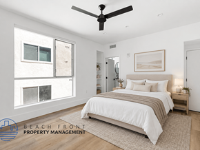West Hollywood apartment for rent - A bedroom with a bed, a ceiling fan, and a rug in front of it.