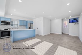 San Pedro townhouse for rent - A modern kitchen with blue cabinets and a white countertop.