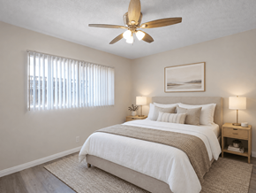 Long Beach apartment for rent - A bedroom with a large bed and a ceiling fan.