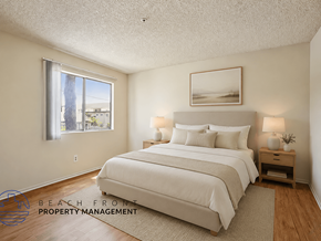 Santa Ana apartment for rent - A well-lit bedroom with a large bed and a window overlooking a beach.