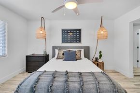 Newport Beach apartment for rent - A bedroom with a large bed and a ceiling fan.