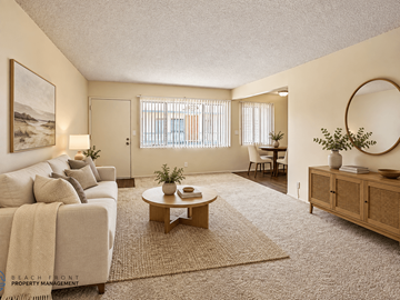Gardena apartment for rent - A living room with a couch, coffee table, and a painting on the wall.
