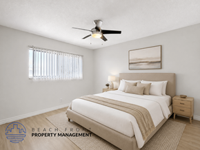 Inglewood apartment for rent - A well-lit bedroom with a large bed and a ceiling fan.