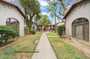 Riverside apartment for rent - A row of houses with a sign that says Beach Front Property Management.