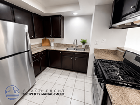 Hawthorne apartment for rent - A kitchen with a refrigerator, sink, and cabinets.