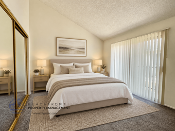 Lawndale apartment for rent - A bedroom with a large bed, a painting on the wall, and a carpet on the floor.