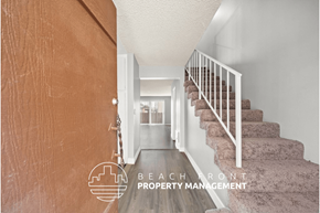 Inglewood townhouse for rent - a view of the hallway of a house with stairs and a hallway with a door