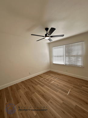 Santa Ana apartment for rent - A room with a ceiling fan and wooden flooring.