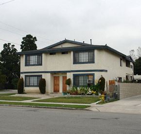 Midway townhouse for rent - a white house with black windows and a sidewalk