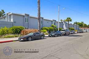 Anaheim apartment for rent - a row of cars parked on a street in front of a building