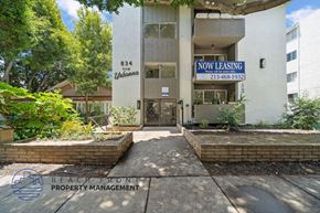 Santa Monica apartment for rent - A building with a sign that says "Now Leasing" is surrounded by greenery.