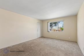 Inglewood apartment for rent - A room with a window showing a view of a house and trees outside.