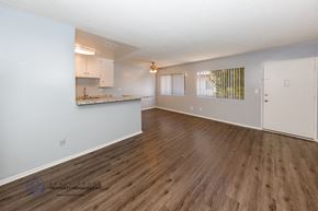 Gardena apartment for rent - A spacious room with wooden flooring and white walls.