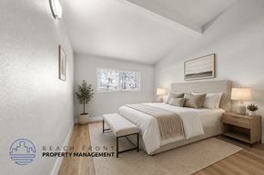 Anaheim apartment for rent - A well-lit bedroom with a large bed and a small plant on the side table.
