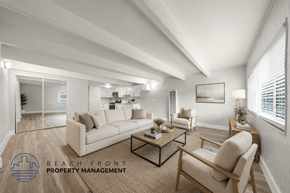Anaheim apartment for rent - A well-lit, modern living room with a large mirror and a coffee table.