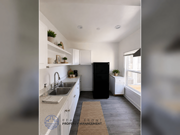 Los Angeles apartment for rent - A kitchen with a sink, a refrigerator, and a window.