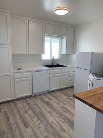 Hermosa Beach apartment for rent - A kitchen with white cabinets and a wooden counter.