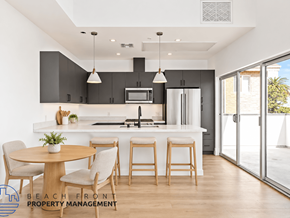 West Hollywood apartment for rent - A modern kitchen with a dining table set for four.