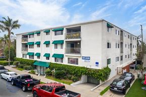 Long Beach apartment for rent - A multi-story apartment building with a blue sign that says "The Leasing Service" on the front.