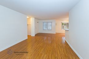Los Angeles apartment for rent - the living room and dining room of a house with wood floors and white walls