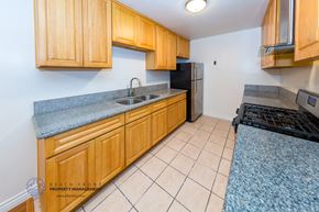 Los Angeles apartment for rent - A kitchen with wooden cabinets and a black refrigerator.
