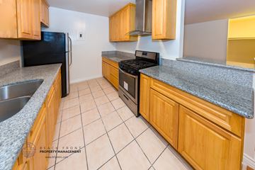 Los Angeles apartment for rent - full kitchen with wood cabinets and granite counter tops and black appliances