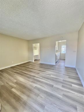 La Habra apartment for rent - A room with wooden flooring and white walls.