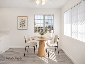 Orange apartment for rent - A dining room with a round table and chairs.