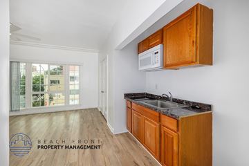 Los Angeles apartment for rent - A kitchen with wooden cabinets and a white microwave.