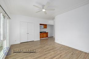 Los Angeles apartment for rent - A spacious room with wooden flooring and a ceiling fan.