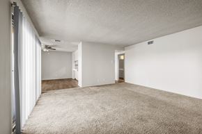 Inglewood apartment for rent - A spacious room with carpeted floor and white walls.