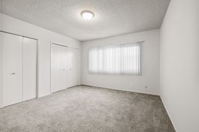 Inglewood apartment for rent - A white bedroom with a window covered in blinds.