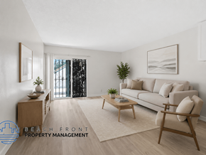 Inglewood apartment for rent - A living room with a couch, a table, and a plant.