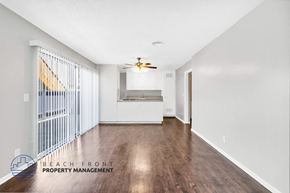 Costa Mesa apartment for rent - A spacious room with wooden floors and a ceiling fan.