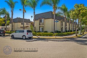Anaheim apartment for rent - a van parked in front of a building with palm trees